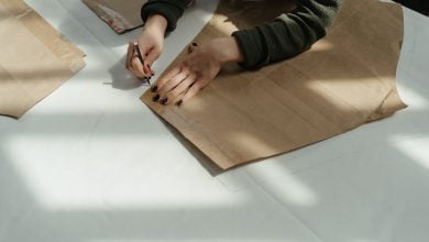 person in black and gray long sleeve shirt holding brown wooden board